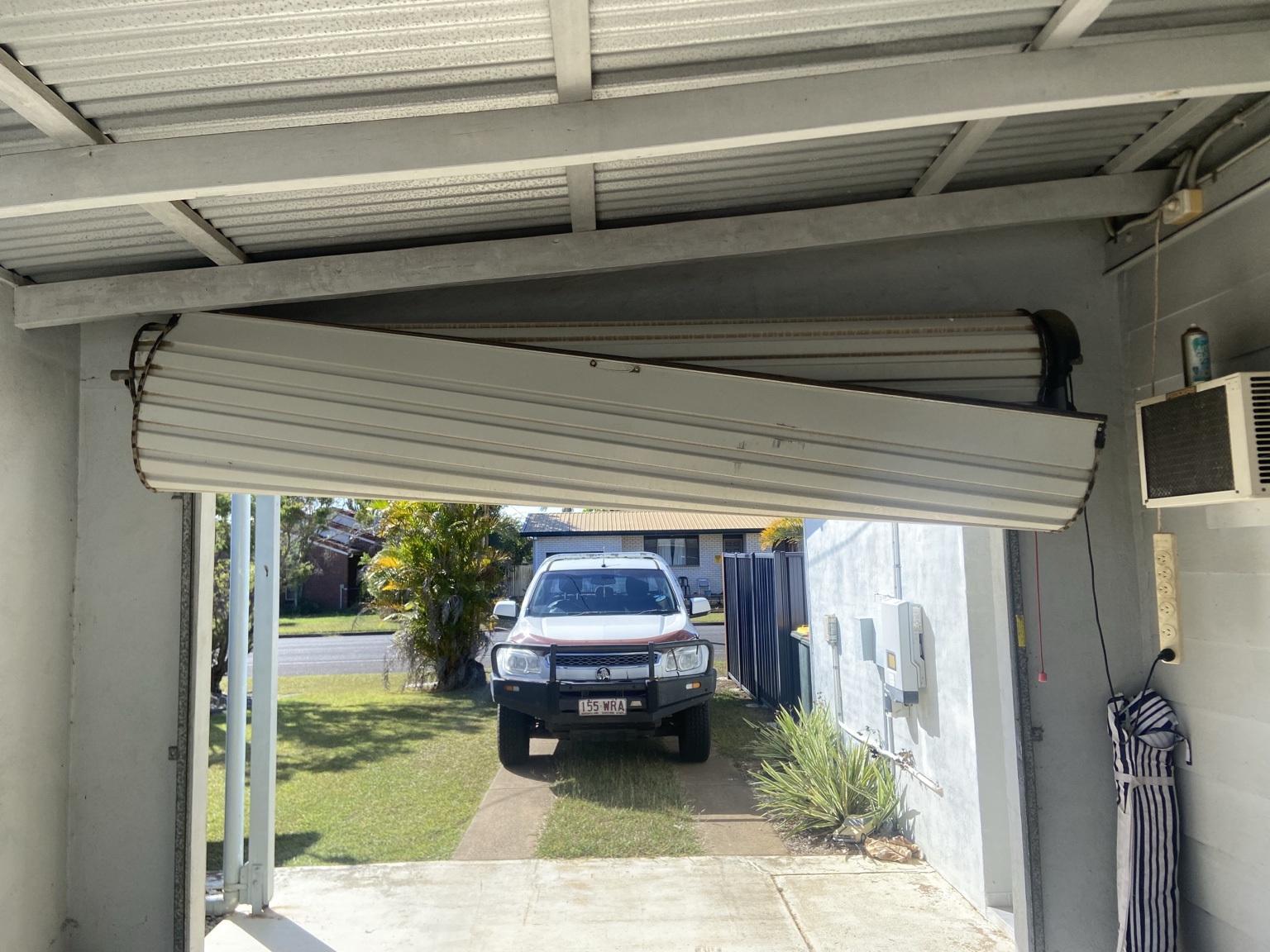 Damaged roller door hanging unevenly